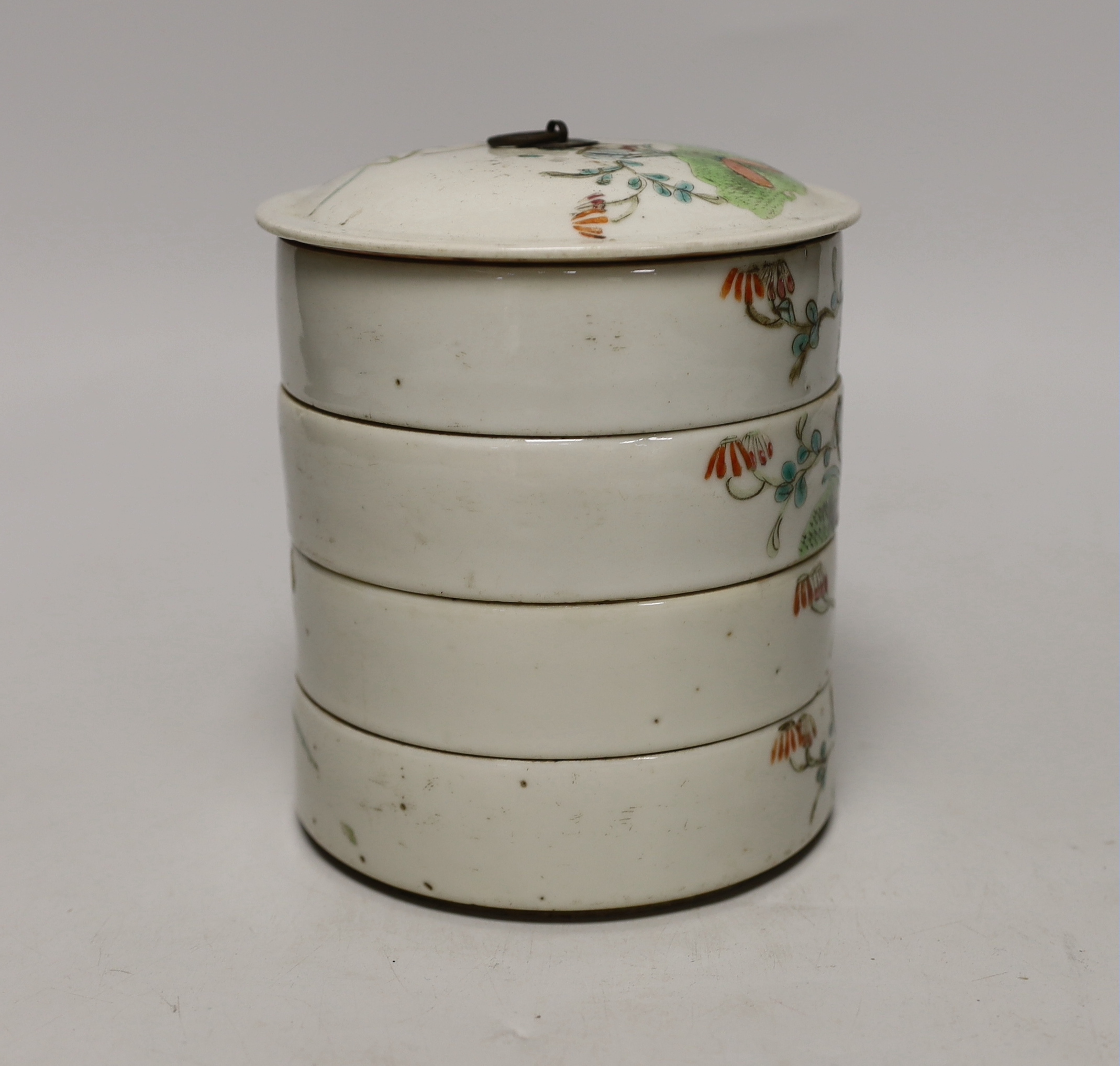 An early 20th century Chinese enamelled porcelain four section stacking food container and cover, 14cm high